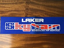 Skytrain Adhesive Advertising Banner. It uses the integrated images of the US and the UK flags. SkyTrain Banner.jpg