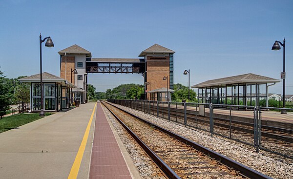 The platforms, tracks and pedestrian bridge at Sturtevant station.