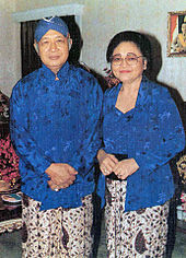 Suharto and wife, Tien, in traditional Javanese attire. His authoritarian New Order regime has been criticised as "Javanising" Indonesian politics. Suharto and wife in Javanese attire.jpg