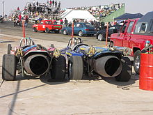 Dual braking parachutes fitted to jet dragsters. The parachutes are in the smaller tubes with yellow straps. Tarlton-Drag racing-002.jpg