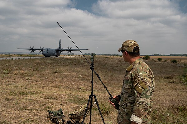 An air traffic controller assigned to the wing's 435th Contingency Response Squadron observes a C-130 Hercules landing on a highway strip during an ex