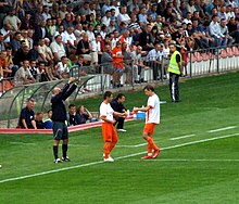 Fourth official notifying the referee of the details of the substitution Tomasz Zelazowski Krystian Kanarski KSZO.jpg