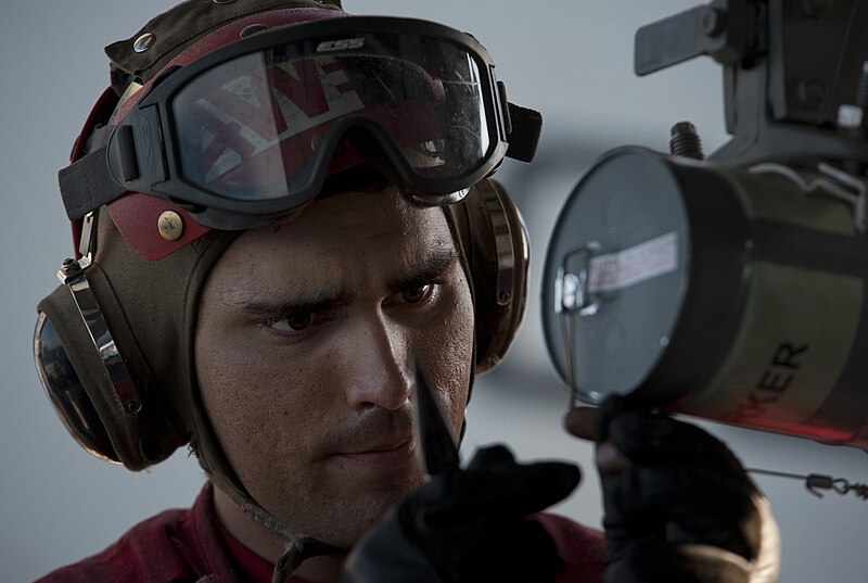 File:US Navy 110131-N-7981E-427 Aviation Ordnanceman Airman Fernando Carrillo secures a smoke marker to a weapons pylon on an F-A-18C Hornet aboard USS.jpg