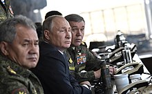Putin with Russia's long-serving Defense Minister Sergei Shoygu (left) and Chief of the General Staff Valery Gerasimov at the Vostok 2018 military exercise Vostok-2018 military manoeuvres (2018-09-13) 23.jpg