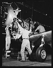 Hanging an engine on a BT-13 Valiant trainer at the Vultee aircraft plant, Downey, California in World War II. Vultee Downey.jpg