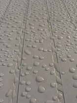 Water drops on hydrophobic plastic garden table