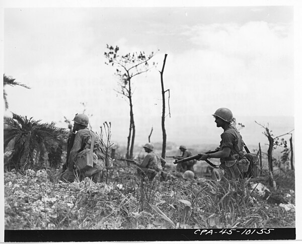 Riflemen of the 2nd Bn., 381st Regiment of the 96th Division peer cautiously ahead as they advance across the summit of Yaeju-Dake escarpment (Big App