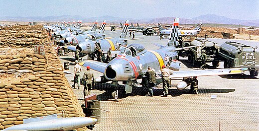 USAF North American F-86 Sabre fighters from the 51st Fighter Interceptor Wing Checkertails are readied for combat during the Korean War at Suwon Air Base