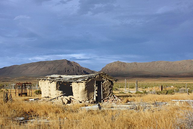 Derelict building off State Route 305 in the Reese River Valley with the Shoshone Range in the distance