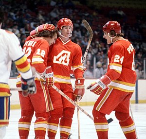 Tom Lysiak (l.) celebrates with Dave Shand and Harold Phillipoff after a goal against the Colorado Rockies in 1978. Atlantaflamesgoalhug.jpg