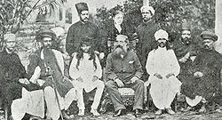 H.P. Blavatsky standing behind Henry Steel Olcott (middle seated) and Damodar Mavalankar (seated to his left). Bombay 1881