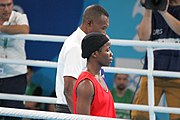 Deutsch: Boxen bei den Olympischen Jugendspielen 2018 Tag 12, 18. Oktober 2018 - Finale Fliegengewicht Mädchen – Martina La Piana (Italien, blau) schlägt Adijat Gbadamosi (Nigeria, rot) 5-0; Ringrichter ist James Beckles (Trinidad und Tobago). English: Boxing at the 2018 Summer Youth Olympics on 18 October 2018 – Girl's flyweight Gold Medal Bout - Martina La Piana (Italy, blue) beats Adijat Gbadamosi (Nigeria, red) 5-0; Referee is James Beckles (Trinidad and Tobago). Español: Boxeo en los Juegos Olímpicos Juveniles de Verano de 2018 en 18 de octubre de 2018 - Combate a medalla de oro de peso mosca para mujeres: Martina La Piana (Italia, azul) le gana a Adijat Gbadamosi (Nigeria, roja) 5-0; El árbitro es James Beckles (Trinidad y Tobago).