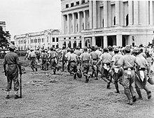 Japanese POWs are taken to work where they were made to clear up the city during the British reoccupation in September 1945 British Reoccupation of Singapore, 1945 IND4826.jpg