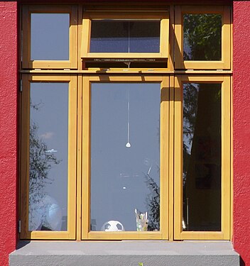 light would colour of window contrasting well to deep red wall paint.