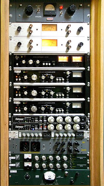 A rack of audio compressors in a recording studio. From top to bottom: Retro Instruments/Gates STA level; Spectra Sonic 610; Dbx 162; Dbx 165; Empiric