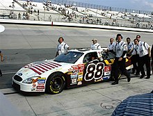 Dale Jarrett won the pole for the race. His car featured an American flag on the hood. Dale Jarret end of happy hour (2686398754).jpg