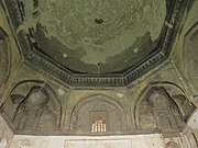 Early example of basic tripartite muqarnas squinches under the dome of the Duvazdah Imam Mausoleum in Yazd (1037–8)