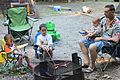 Father teaching sons the basics of cooking hotdogs by the fire at Pocahontas State Park. (7516279380).jpg