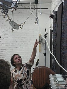 Gordon Monahan explaining his stringed instrument, Robotics & Music Workshop, NIME 2007.jpg