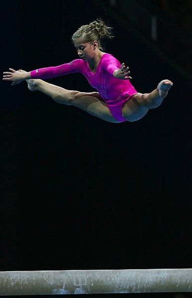 File:Gymnast jumping on beam.jpg