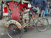 A becak and its driver wait for a fare in Bandung, Indonesia