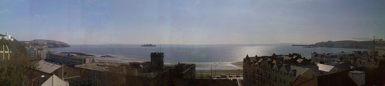View of the bay showing visible landmarks of the Castle Mona hotel staircase turret (centre) and Onchan Head to left