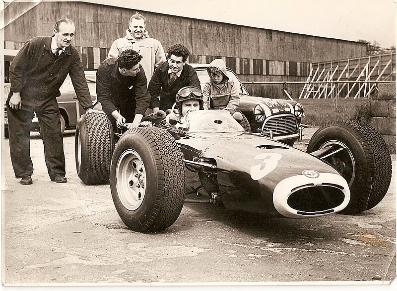 File:J Crosthwaite in duffel coat with Graham Hill in BRM.jpg