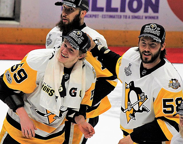 Letang (right foreground) celebrates with Jake Guentzel and Nick Bonino after the Penguins won the 2017 Stanley Cup Finals