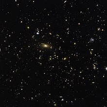 The brilliant central object is the supergiant elliptical galaxy SDSS J142347.87+240442.4, the dominant member of the galaxy cluster MACS J1423.8+2404. It has a diameter of 380,000 light-years. Note the gravitational lensing. MACSJ1423.8+2404.jpg
