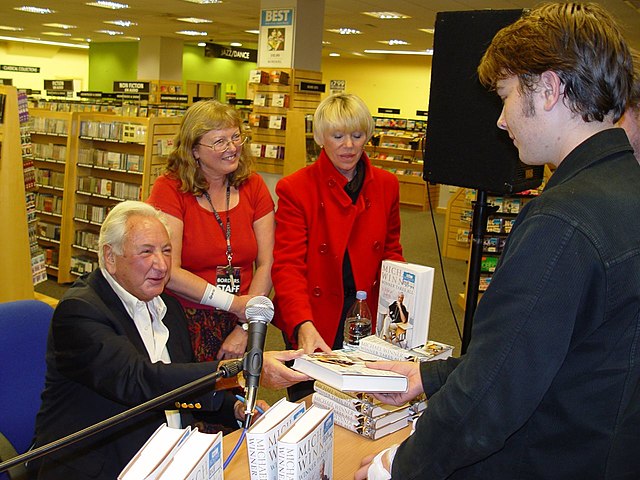 Winner, with Geraldine Lynton-Edwards (red jacket), at a book signing for his autobiography