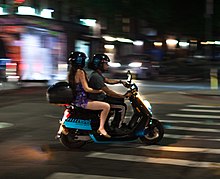 New York City couple on a Revel scooter in 2019 Night on the town (Revel scooter in New York City) (cropped).jpg