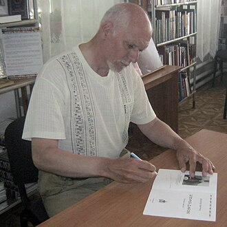 Pinchuk autographing a copy donated to the library.
