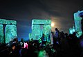 Revelers dance at the centre of the henge