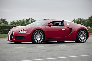 Red Bugatti Veyron on the road (7559997596).jpg
