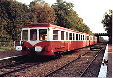 Foto eines Triebwagens, der eine Station überquert.