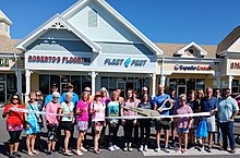 Ribbon-cutting ceremonies often involve an oversized pair of scissors Ribbon Cutting The Villages FL.jpg