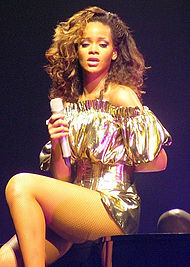 Recording artist Rihanna contributed vocals to "Take Care". Rihanna, LOUD Tour, Belfast cropped 2.jpg