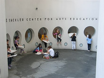 Students sketching at the entrance to the Sackler Center