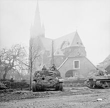 A Cromwell tank of 5th Royal Inniskilling Dragoon Guards supporting infantry in Weseke, 29 March 1945. The British Army in North-west Europe 1944-45 BU2823.jpg