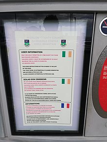 Sign in the Republic of Ireland using the Irish flag for both English and Irish Trilingual sign in Ireland with Irish flag for English language.jpg