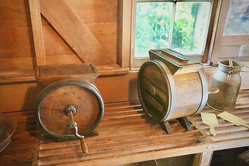 File:Two butter churns and a cream can at the The Elms - Formerly the Te Papa Mission Station.jpg