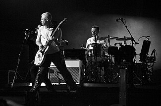 Larry Mullen, Jr. and U2 playing on stage