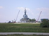 USS Alabama at her permanent berthing still showing a mild list 8 months after Hurricane Katrina.