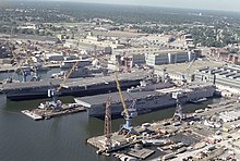 Coral Sea laid up at Norfolk Naval Shipyard in September 1990 alongside the newly commissioned assault ship USS Wasp