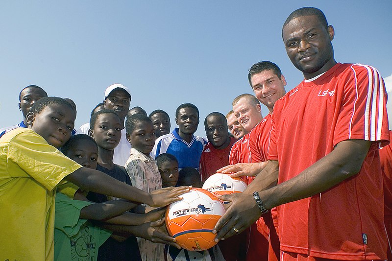 File:US Navy 071123-N-8483H-002 Sailors assigned to the amphibious dock landing ship USS Fort McHenry (LSD 43) present soccer balls to children in support of Africa Partnership Station (APS).jpg