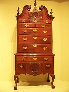 This high chest of drawers, also known as a highboy or tallboy, is part of the Decorative Arts collection of the Indianapolis Museum of Art in Indianapolis, Indiana. Made between 1760 and 1780 in Philadelphia, Pennsylvania, its design was inspired by British furniture-maker Thomas Chippendale.