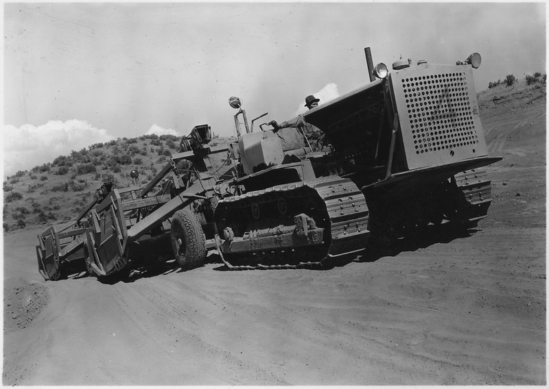 File:"Tractor powered scrapers taking top soil off gravel deposit at pit location." - NARA - 294214.tif