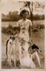 Thumbnail for File:A Chinese woman wearing traditional qipao standing in the bushland with two borzoi dogs in the bushland of Bendigo, Victoria, Australia, 1930.png