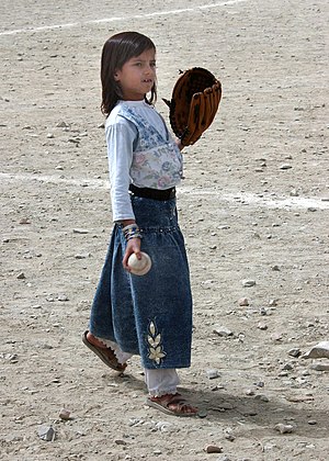 An Afghan girl playing baseball in August 2002