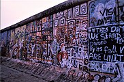Berlin Wall graffiti reads: "In this day we stand divided--by its fall we are united", 1986
